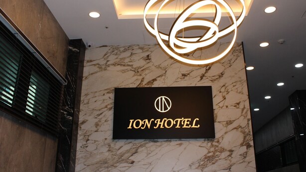 A sign for the Ion Hotel with a modern, circular light fixture above it. - ION HOTEL DONGDAEMOON (Seoul)