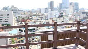 A cityscape with a variety of buildings, including high-rise structures and smaller commercial buildings. - ION HOTEL DONGDAEMOON (Seoul)