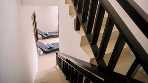 A staircase with black railings and a tiled floor. - Taman Bali Villa Kerobokan (Kerobokan)