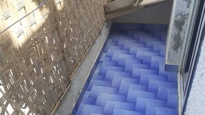 A staircase with blue-tiled steps leading to a landing area. - Captivating 4-Bed House in Tamaris (Tamaris)