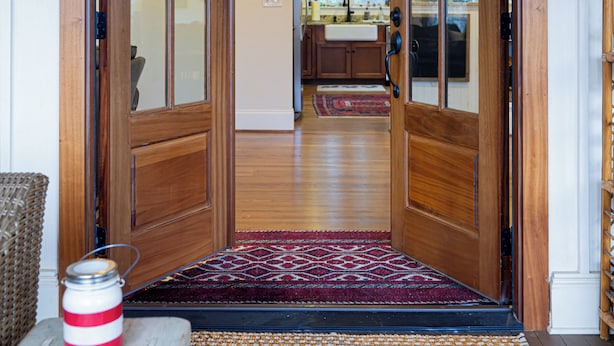 A wooden door leading to a kitchen with a rug at the entrance. - Endearing Lakeside Private Retreat  (Hendersonville)