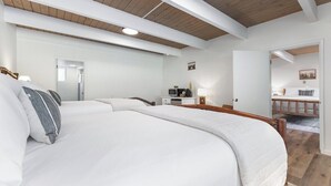 A bedroom with a large bed, a desk with a computer, and a mirror. - Bear's Den Camp Nelson Lodge #5 (Springville)