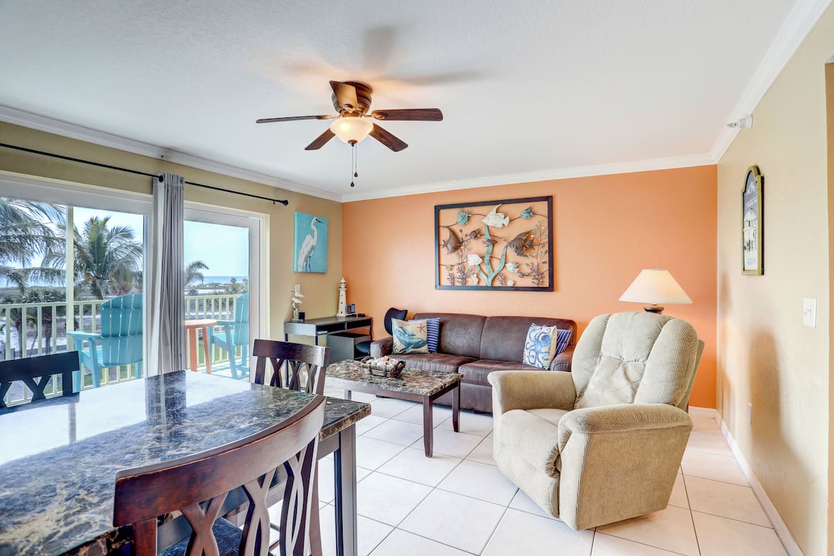 A living room with a ceiling fan, a dining table with chairs, a sofa, and a coffee table.