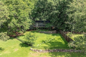 Set amidst a dense forest, this two-story house offers a secluded and environment.