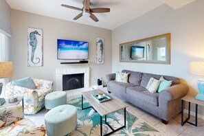 A living room with a fireplace, a television, and a sofa.