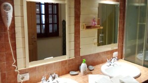 Un baño con dos lavabos, un espejo y un secador de pelo.