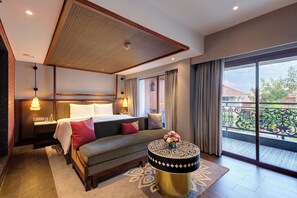 A hotel room with a bed, bedside table, lamp, and a view of the outside balcony. - Gateway Bekal (Hosdurg)