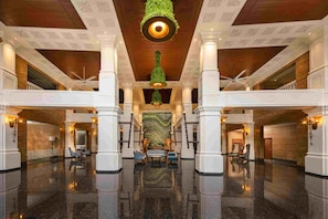 A spacious lobby with high ceilings, polished floors, and classic architectural columns. - Gateway Bekal (Hosdurg)