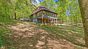 A large house with a porch, surrounded by trees and a well-maintained lawn. - Private Lake House near Enterprise (New Brockton)