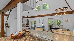 A spacious kitchen with a granite countertop, a welcome sign, and a basket of snacks. - Private Lake House near Enterprise (New Brockton)