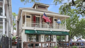 A two-story building with a green awning labeled "The Bean Gallery".