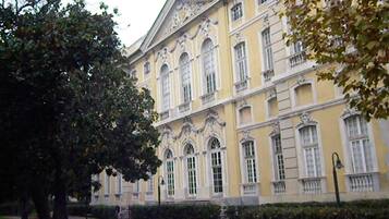 A large, historic building with multiple windows and ornate architectural details.