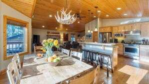 A spacious kitchen with wooden cabinets, a large island, and modern appliances.