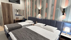 A hotel room with two beds, a wardrobe, a mirror, a wall-mounted TV, and an air conditioning unit. - ASYL HOTEL (Astana)