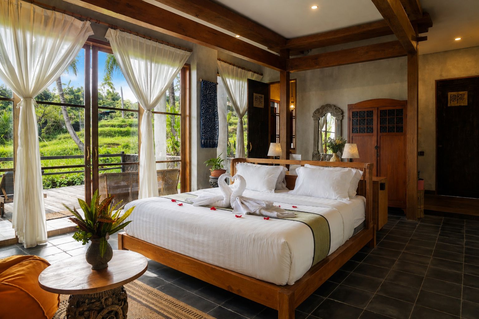 A well-appointed bedroom with a large bed, wooden headboard, and a view of a lush garden.