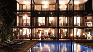 A multi-story hotel with a swimming pool, outdoor seating, and a well-lit facade. - South Point Ocean - Whole Villa 8 Bedroom (Sleep 16) (Koggala)