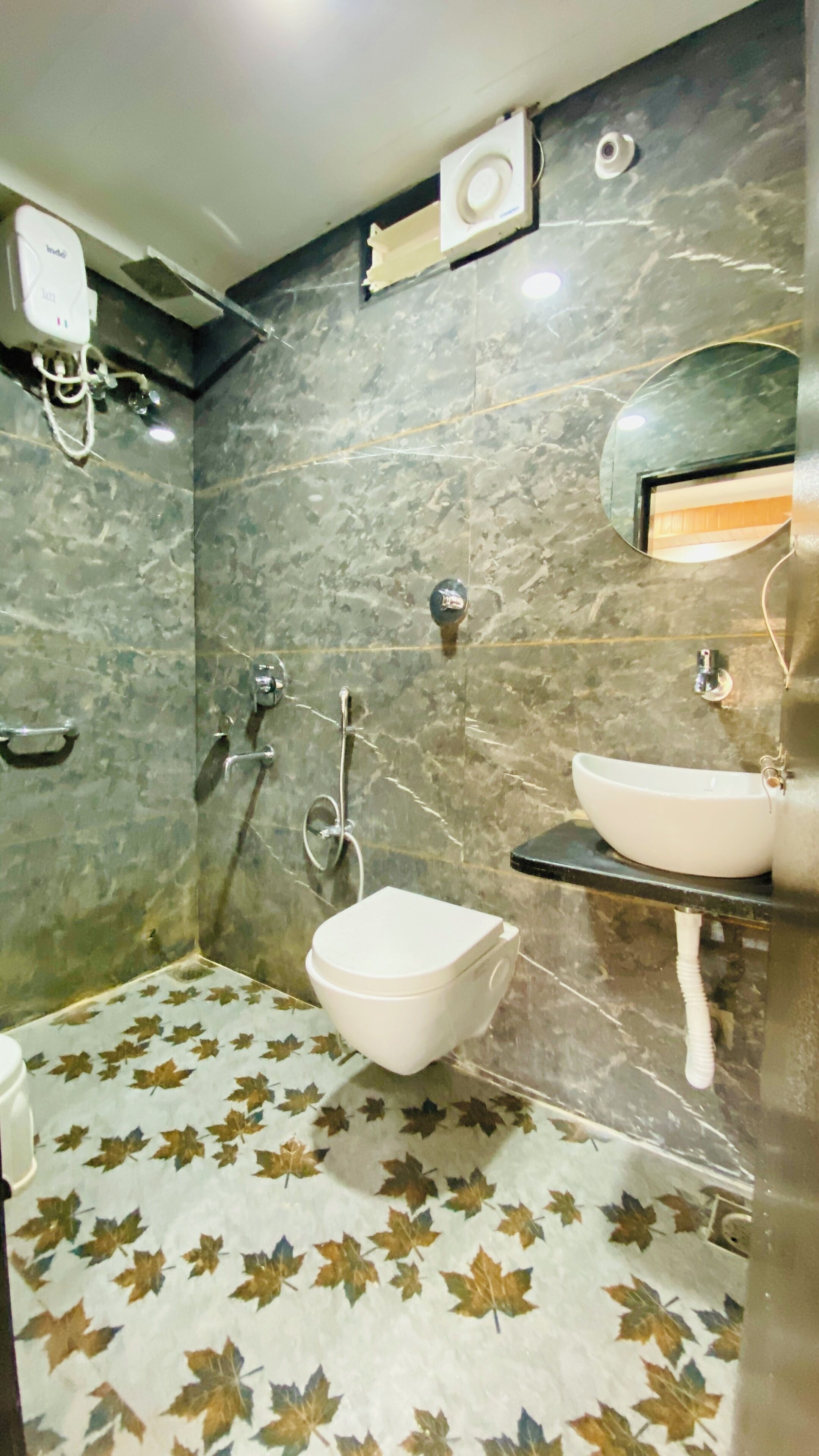 A bathroom with a toilet, bidet, and sink.