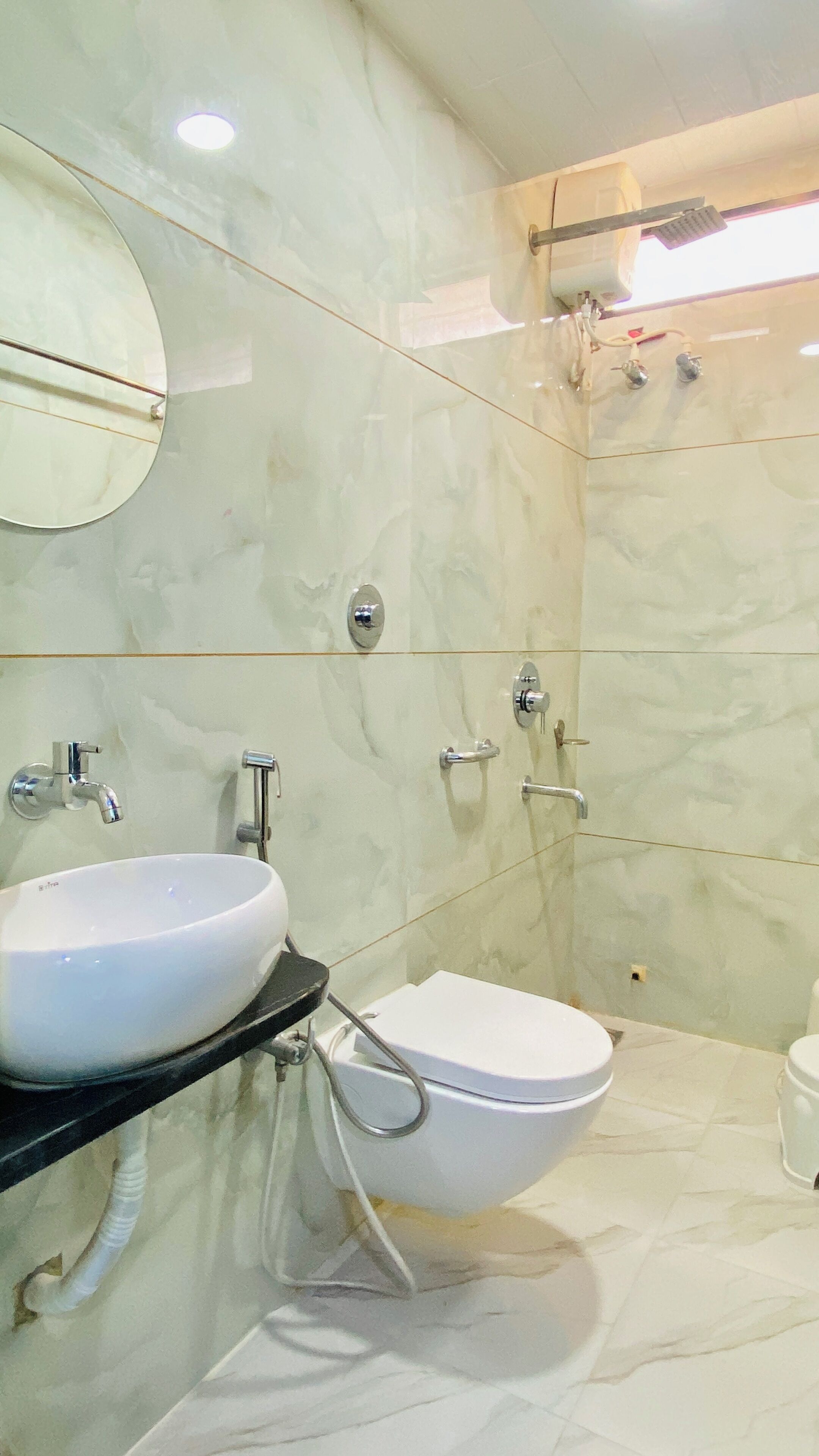 Een badkamer met een witte wastafel, toilet en douche.