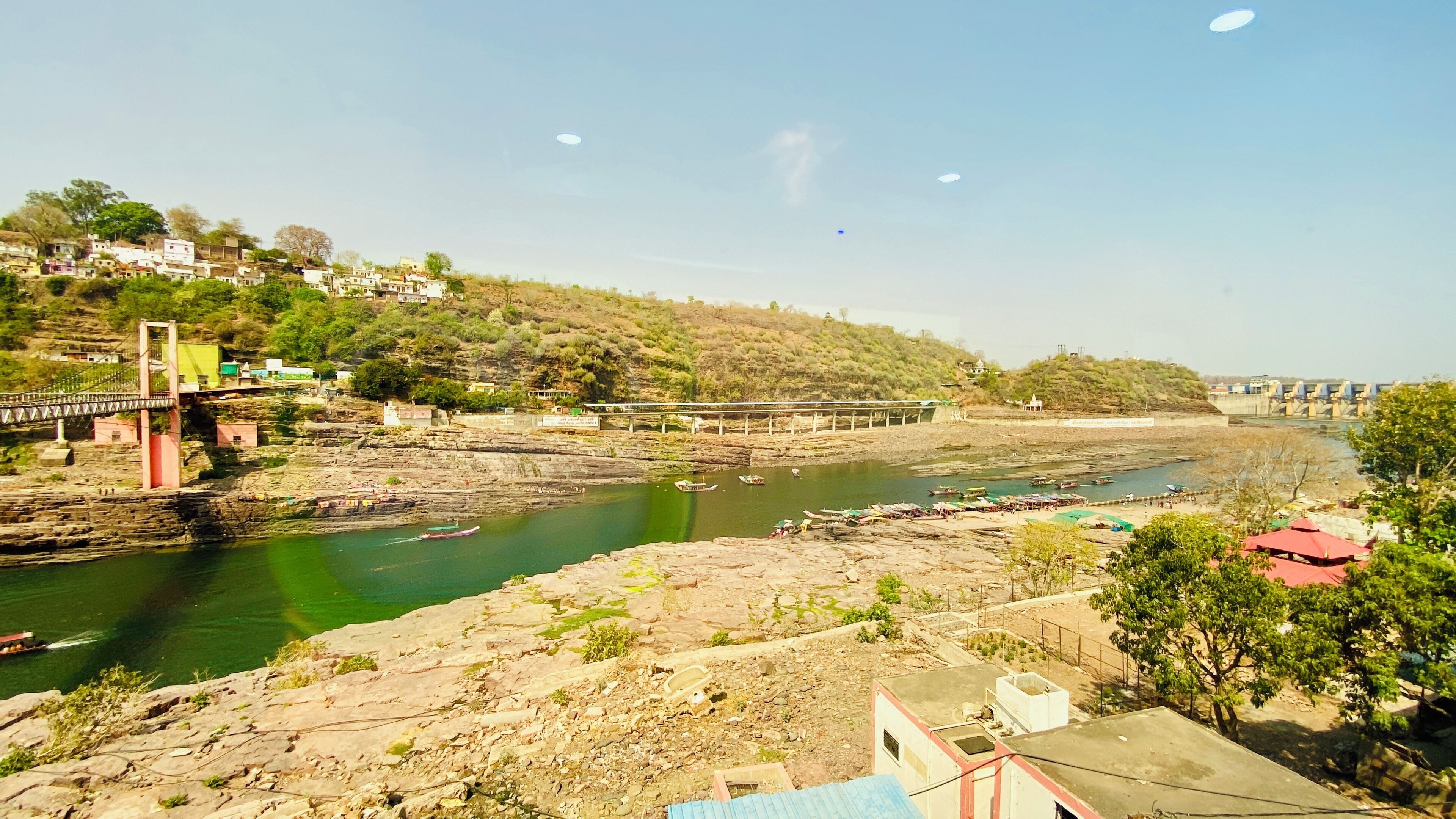 Vista del río con un puente, barcos y edificios a lo largo de la orilla.