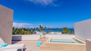 A rooftop terrace with a pool, lounge chairs, and a view of the ocean. - Beach Homes Punta Cana (Punta Cana)