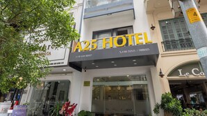 A hotel with a modern facade, a prominent 'A25 HOTEL' sign, and a glass entrance. - A25 Hotel - 14 Ho Huan Nghiep (Ho Chi Minh City)