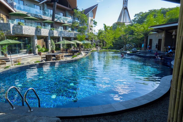 Outdoor pool, pool umbrellas, lifeguards on site