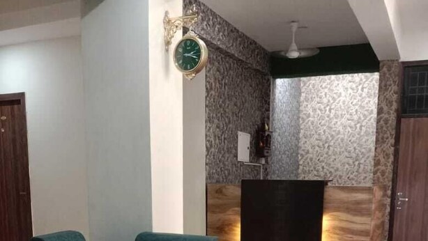 A modern living room with a green sofa, a coffee table, and a fireplace. - Hotel Soho Sector 51 Noida (Noida)