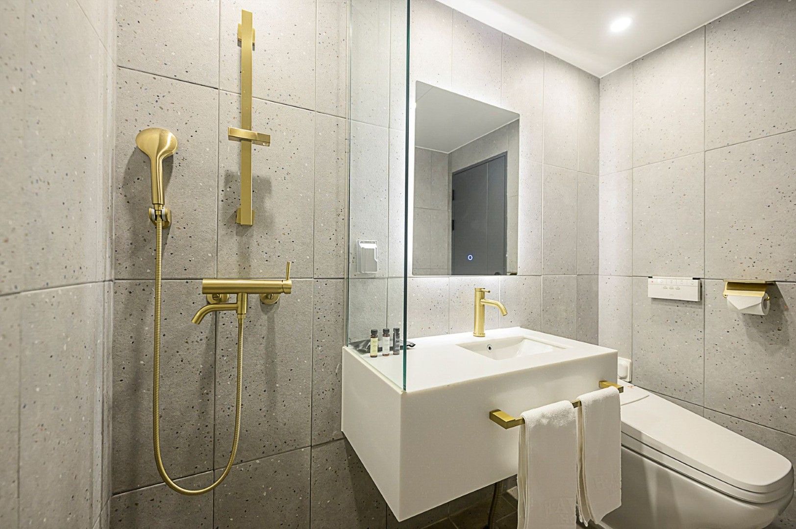 A modern bathroom with a freestanding bathtub, a sink, and a toilet.