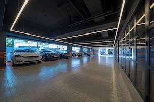 A multi-level parking garage with several cars parked.