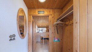 A wooden interior hallway leading to a dining area with a sign indicating a fishing area.