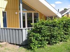 Situated in a residential setting, this single-story building features a large front window and a charming porch.