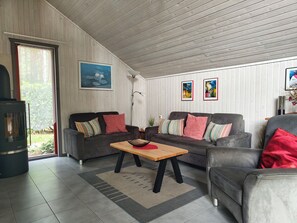 A living room with two sofas, a coffee table, and a fireplace.