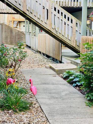 A concrete pathway leading to a wooden bridge with a metal railing. - Boho Flamingo-Pools, Hot Tub, Pet Friendly (Village of Four Seasons)