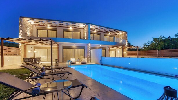 A modern two-story house with a swimming pool, outdoor seating, and a covered patio area.