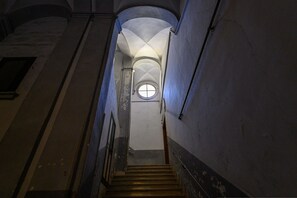 A staircase leading to a domed ceiling with a circular window. - La Stanza del Principe (Naples)