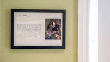 A framed informational display titled "THE ROYALISTS" with text and a historical painting.