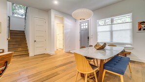 A spacious dining area with a marble table, wooden chairs, and a blue bench. - Spacious Austin Home: Near S Congress & Downtown! (Austin)