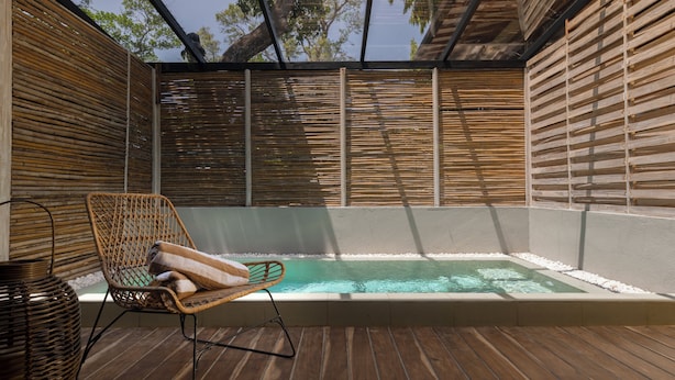 A wooden deck with a hot tub, a wicker chair, and a woven basket. - Ara by Colombo Villas  (Colombo)
