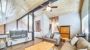 A spacious living room with a foosball table, a sofa, and a coffee table. - Pine Mountain Club Cabin w/ A/C & EV Charger (Pine Mountain Club)