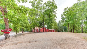 A gravel area with a red building, surrounded by trees. A sign indicates the location as Beaver Lake Villas.