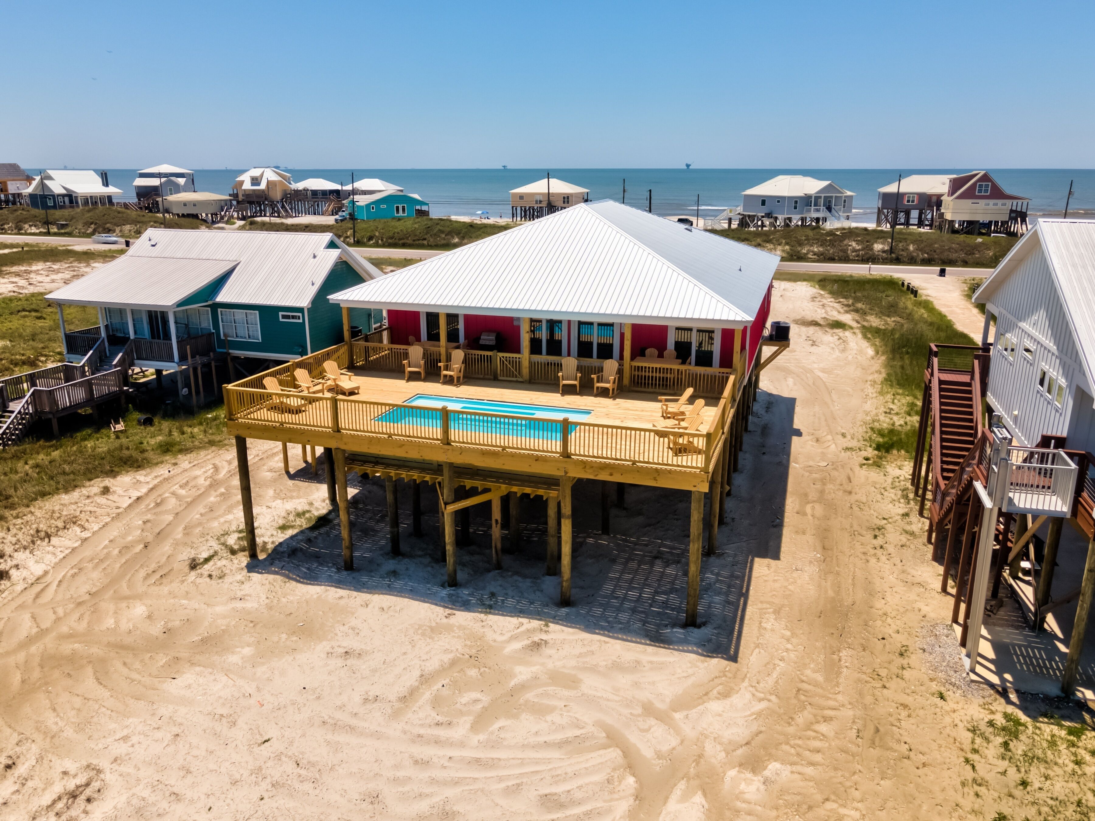 A beach house with a pool, wooden deck, and multiple levels.