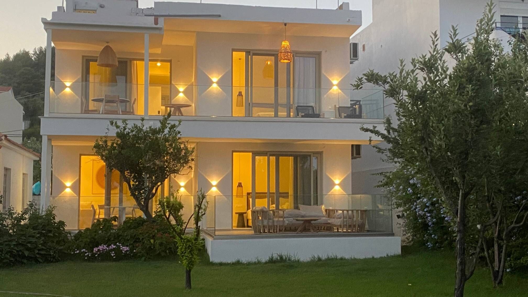 A two-story building with a balcony and a dining area.