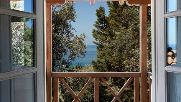 A wooden pergola with a view of the sea and trees. - Villa Ira Skiathos Luxury Villa (Skiathos)
