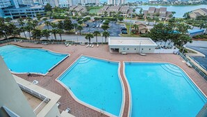 A resort with multiple swimming pools, a parking area, and a view of the ocean. - Ariel Dunes II 708 *Stunning Beach Views*Pools* (Miramar Beach)