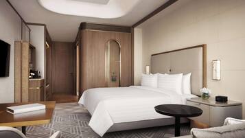 A modern hotel room with a large bed, a desk, a chair, a small table, a nightstand, and a TV.