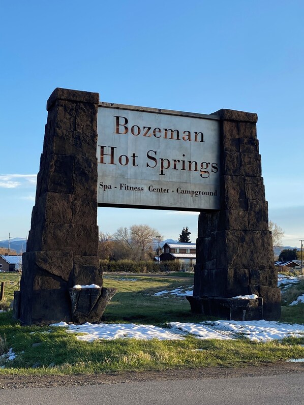 A sign for Bozeman Hot Springs with a spa, fitness center, and campground.