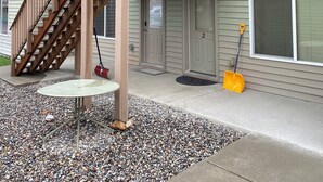 A two-story house with a wooden deck and a staircase leading to the upper floor. - Close to Bozeman Airport (Belgrade)