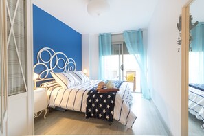 A bedroom with a bed, bedside table, and curtains.