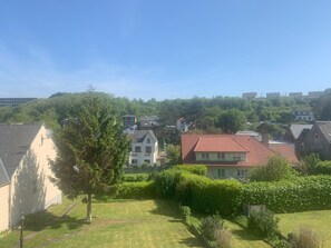Zona residencial con casas, un árbol y cielo despejado.