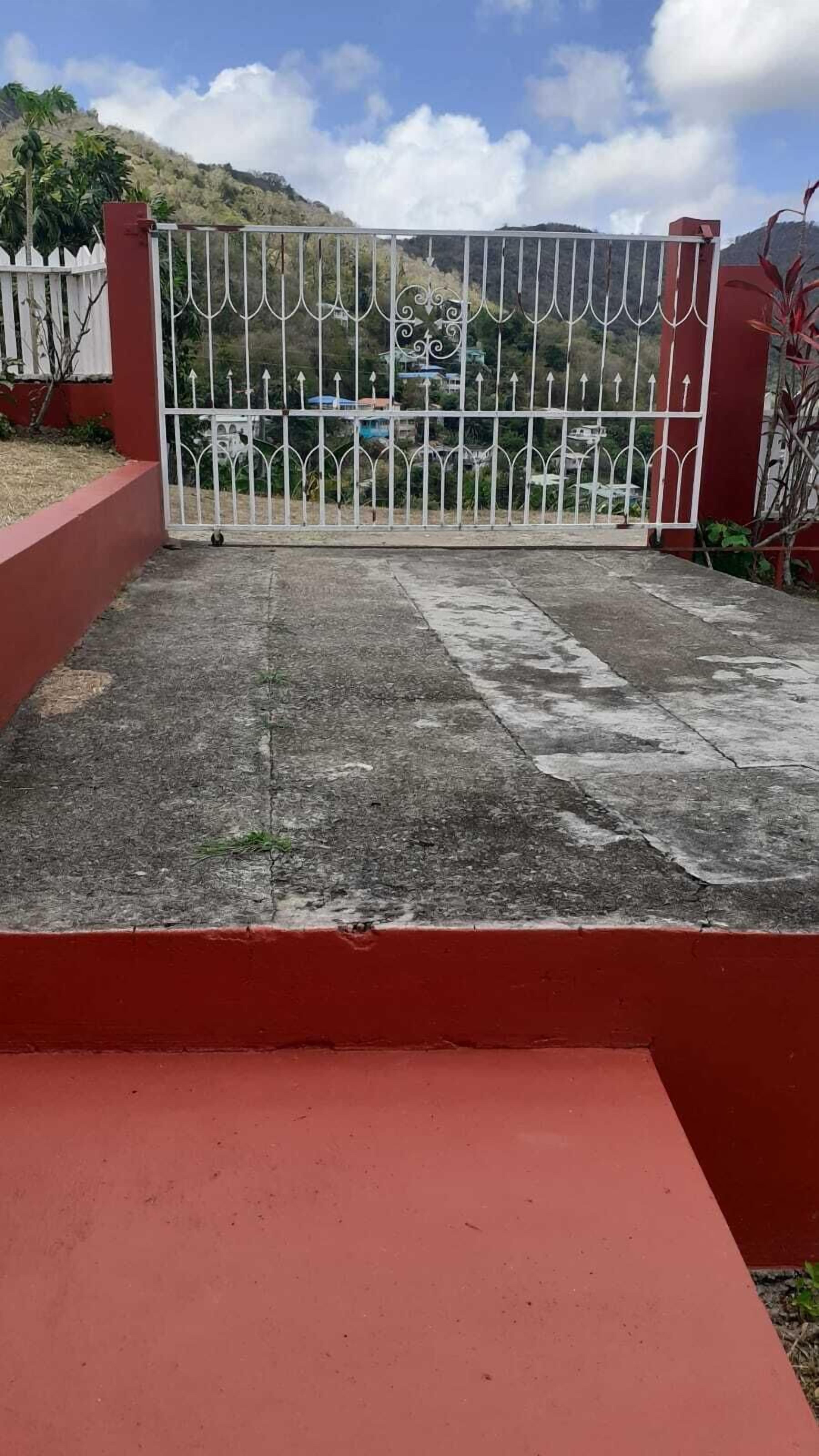 A gated patio area with a red border and a metal gate.